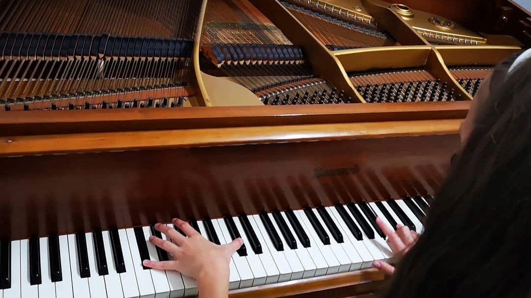 A student enjoying our grand piano